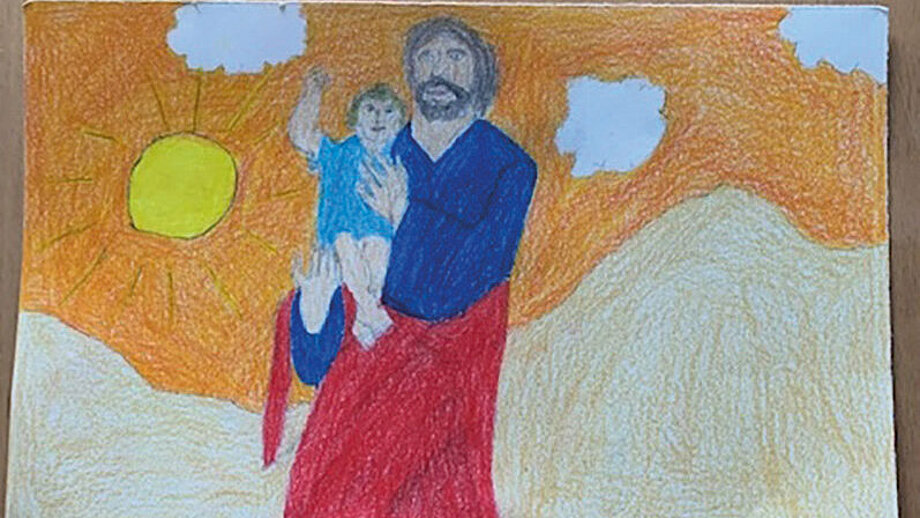 Ein Bild zeigt Josef als liebenden Vater, der Jesus auf den Arm hält. 